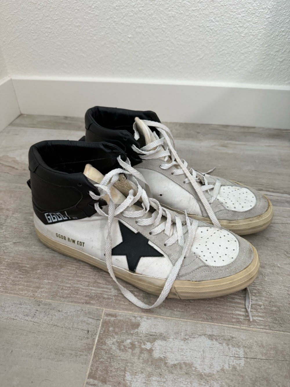 Golden Goose Deluxe Brand Mid Star model in a white and black colorway.